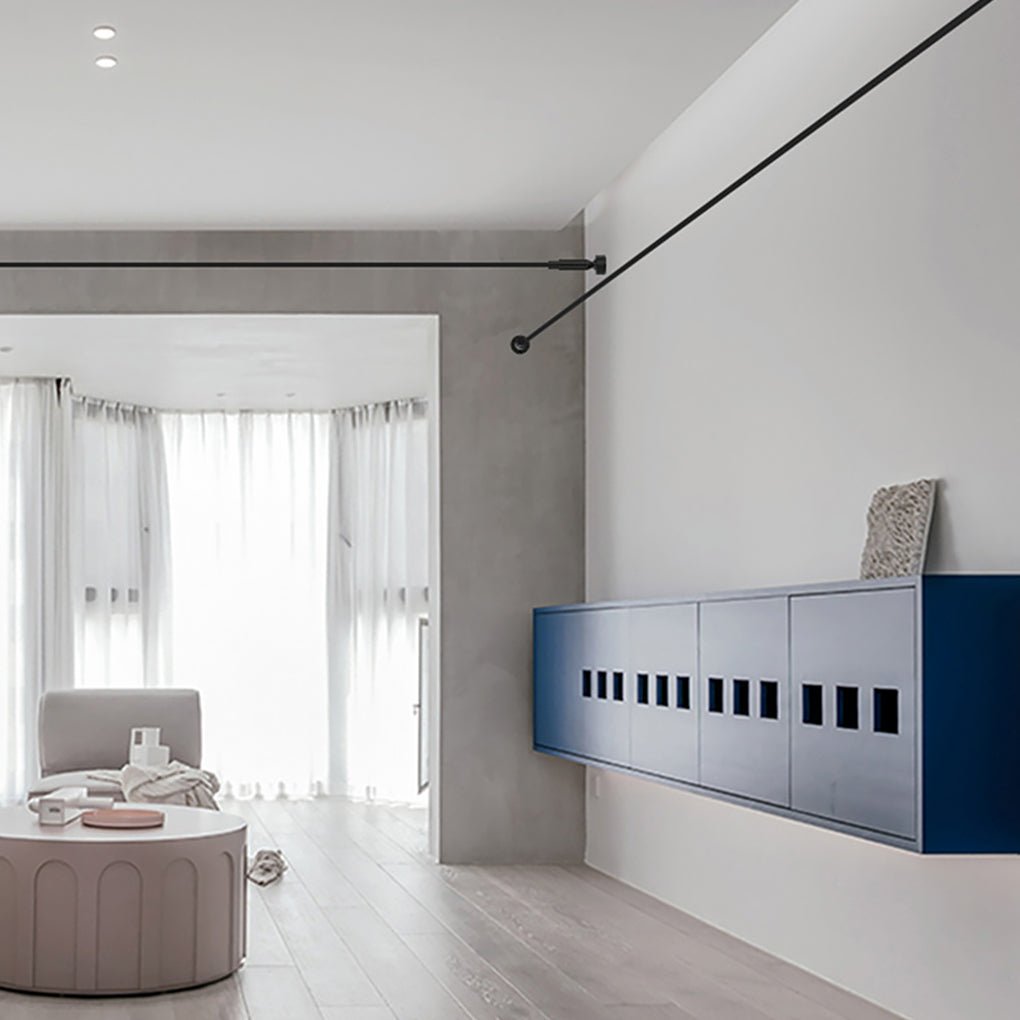 Minimalist black led lights strips for room installed across a white wall above a blue cabinet.