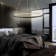 Black LED ring chandelier installed above bed in modern bedroom interior.