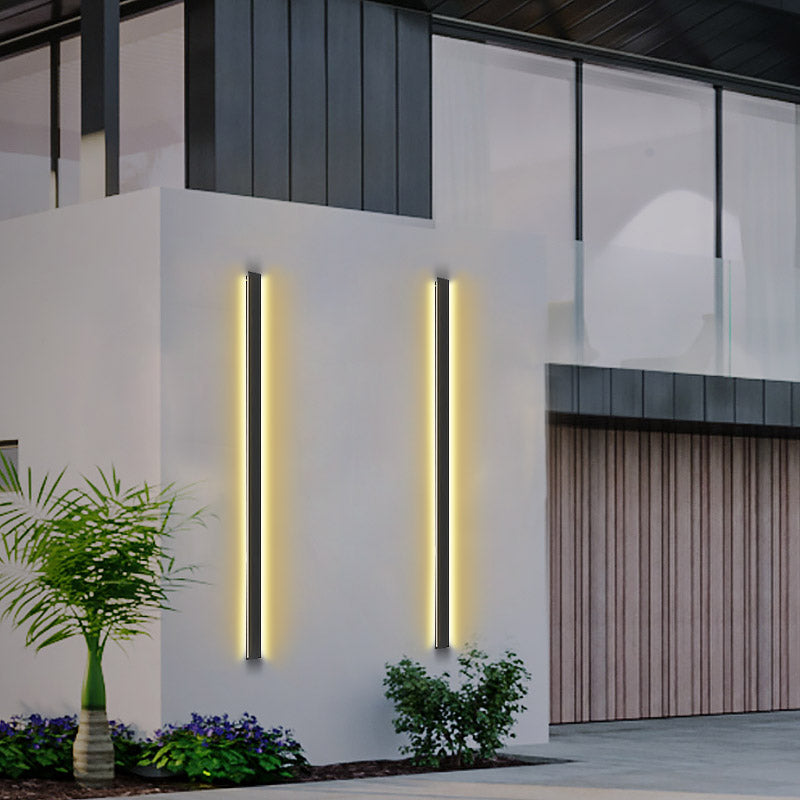 Black linear wall light with a close-up of its minimalist design and vertical light.