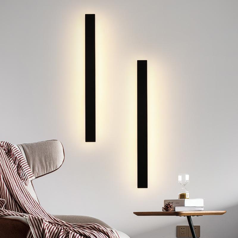 Black linear wall sconce with a close-up of its sleek black frame and light.