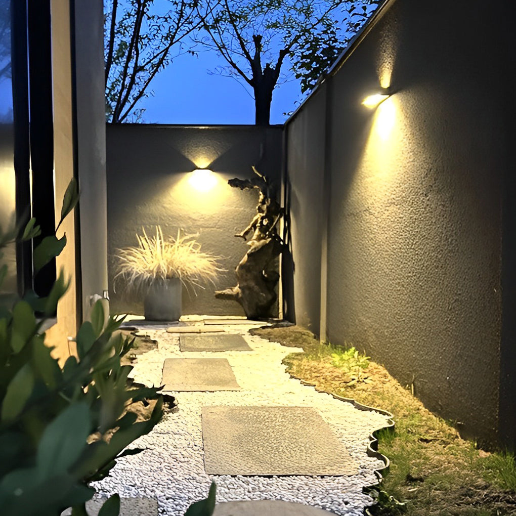 Black motion sensor outdoor wall light with close-up of its motion sensor and light output.