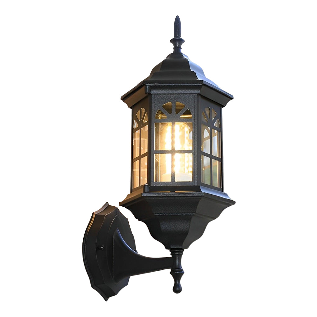 Black outdoor lantern sconce with a close-up of the illuminated glass panels.