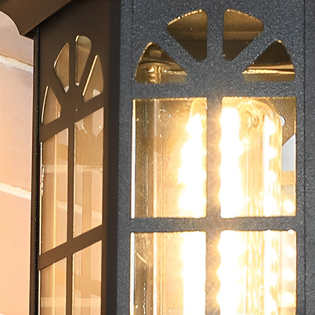 Black outdoor lantern sconce providing warm light beside a brick wall.