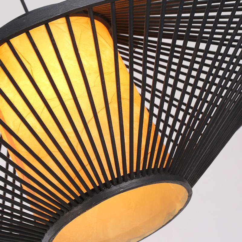 Black rattan pendant light with a geometric design, providing ambient lighting.
