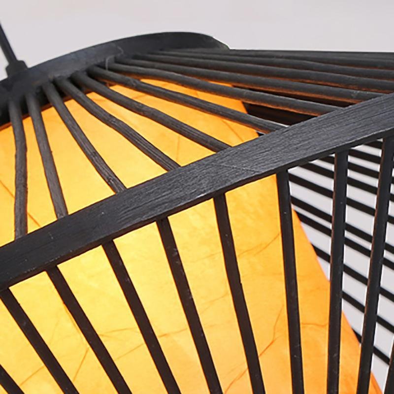 Black rattan pendant light with a woven design, enhancing a contemporary interior.