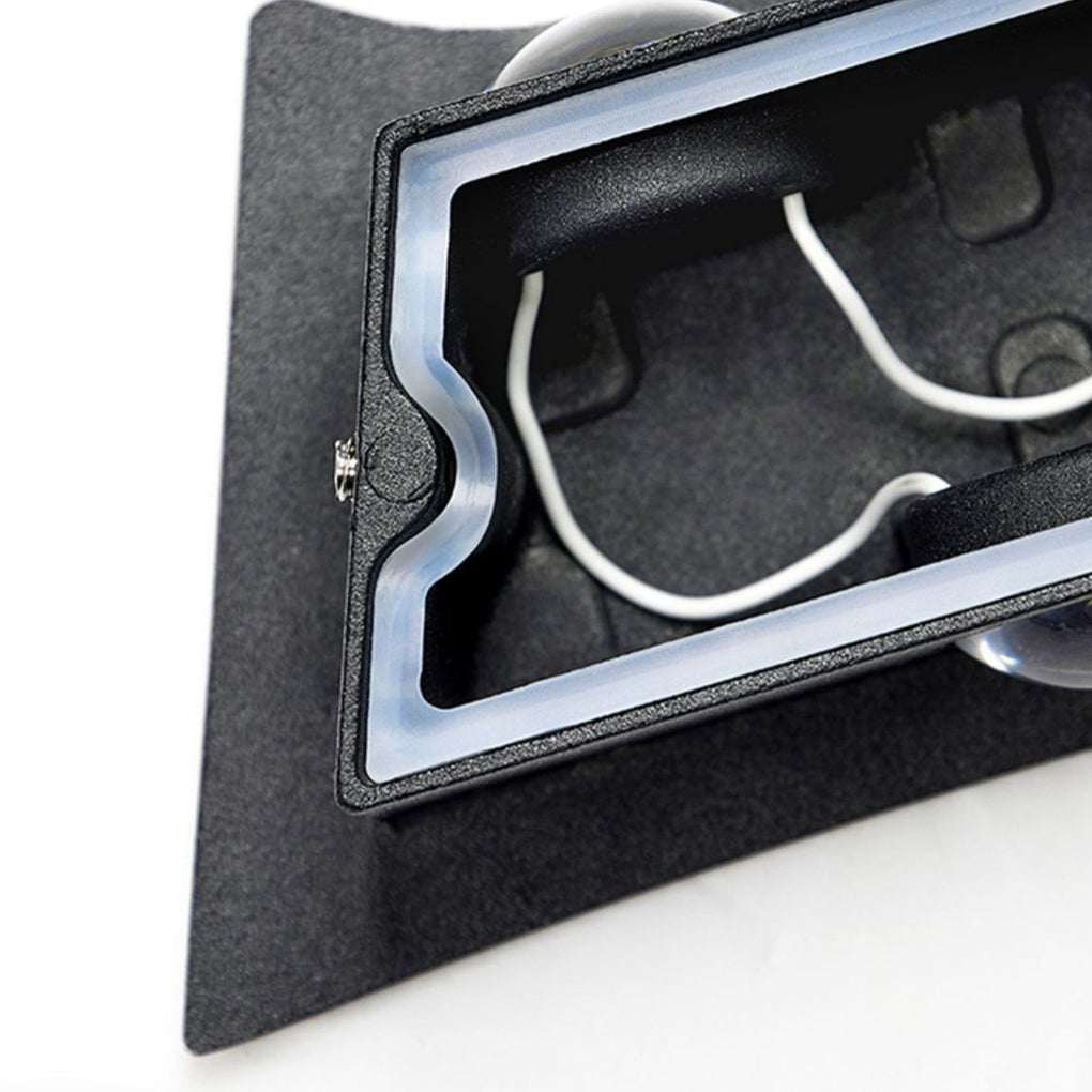 Black up down wall light rear view showing internal wiring space and mounting design for exterior installation.