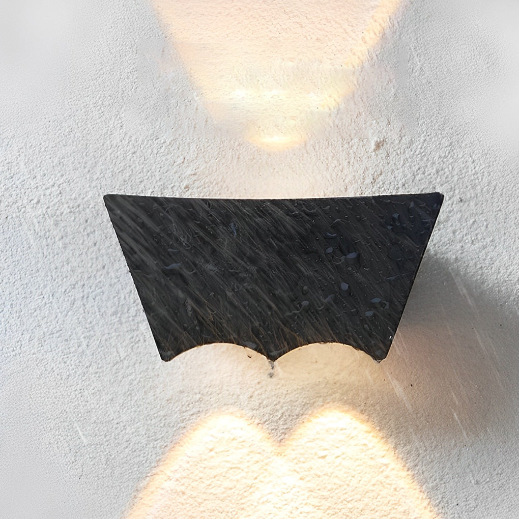 Black up down wall light shown in detail on a light-colored wall, emphasizing the contrast and beam direction.