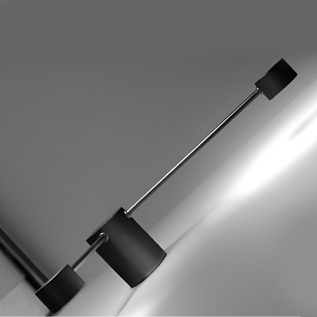 Black wall light with detailed view of its spherical bulbs and structure.