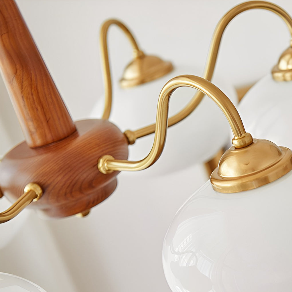 Black walnut brass chandelier with detailed view of its brass arms and shades.