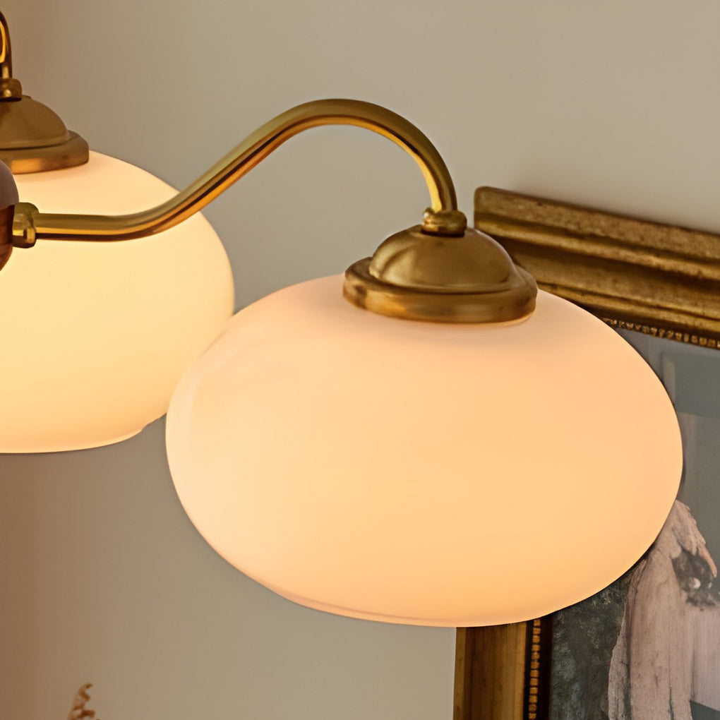 Black walnut brass chandelier with close-up of its ornate design and light output.