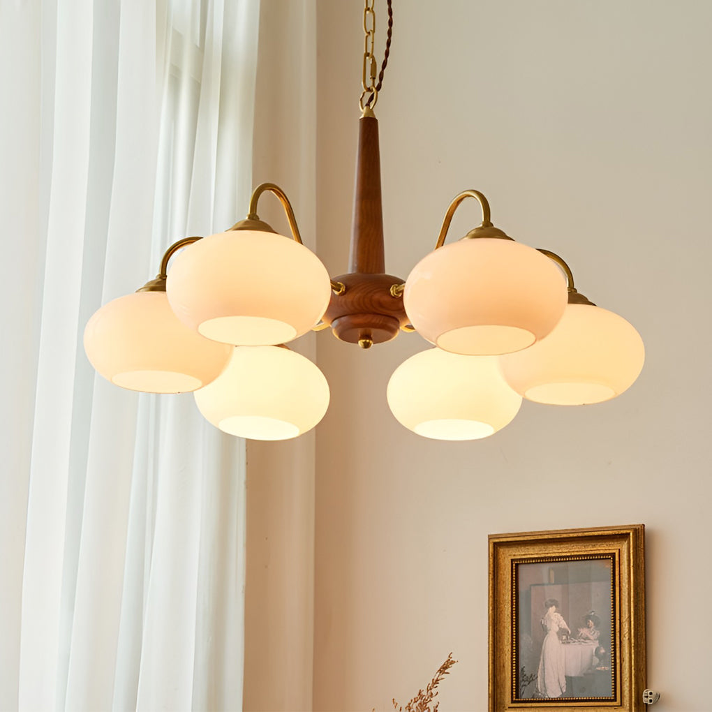 Black walnut brass chandelier illuminating a cozy reading nook with focused glow.