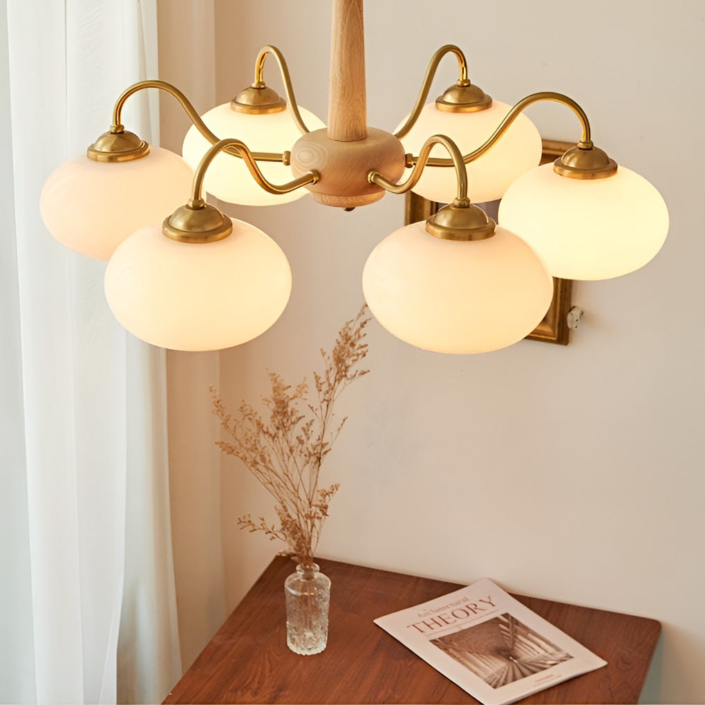 Black walnut brass chandelier providing soft illumination in a stylish kitchen.