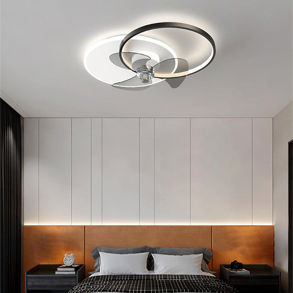 Black and white ceiling fan with integrated LED light installed in a modern bedroom.