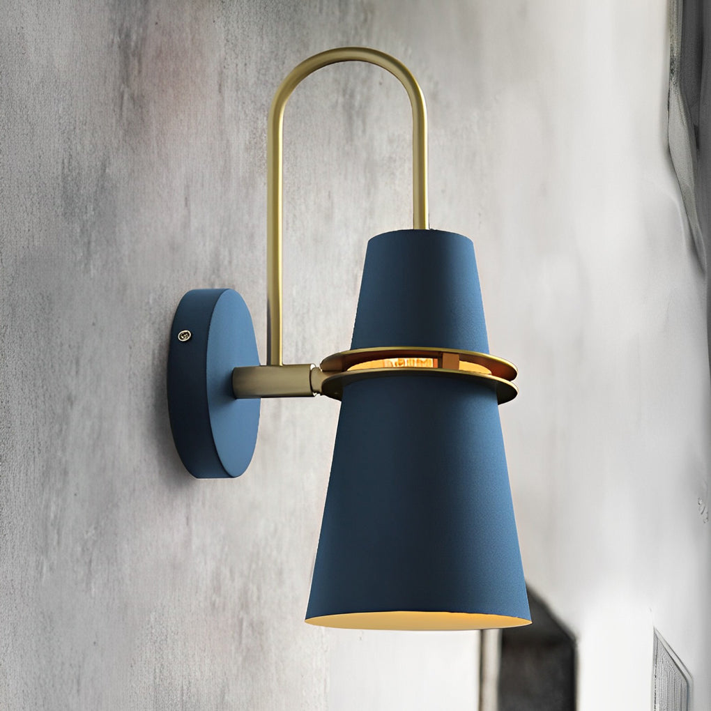 Blue cone wall lamp with gold accent mounted on textured concrete wall.