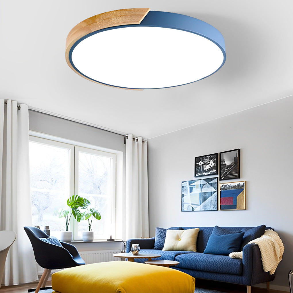 The blue nordic wooden ceiling light glowing warmly in a living room with sofa and ottoman ok.