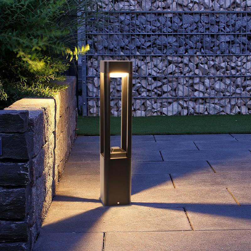 Bollard landscape light placed near a stone wall entryway