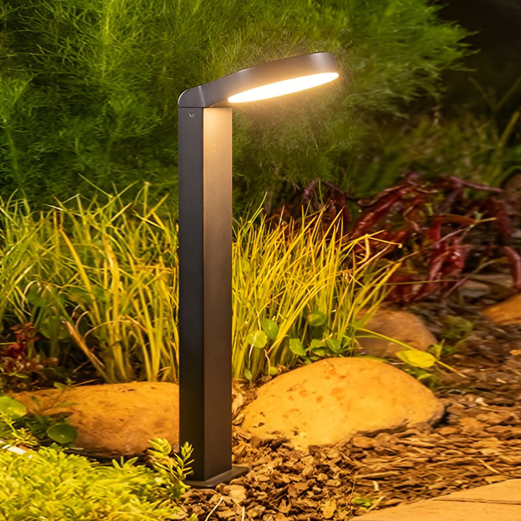 Bollard landscape lights illuminating a minimalist outdoor fence with focused glow.