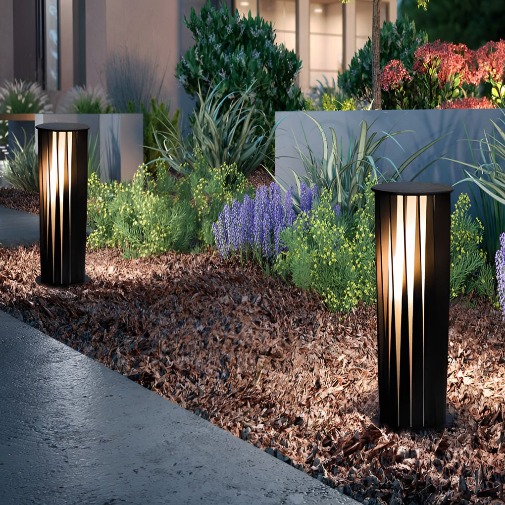 Bollard path lights used in garden bed edging for nighttime visibility.
