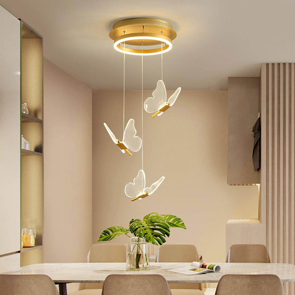 Butterfly chandelier above dining table with cascading crystal-style pendants.