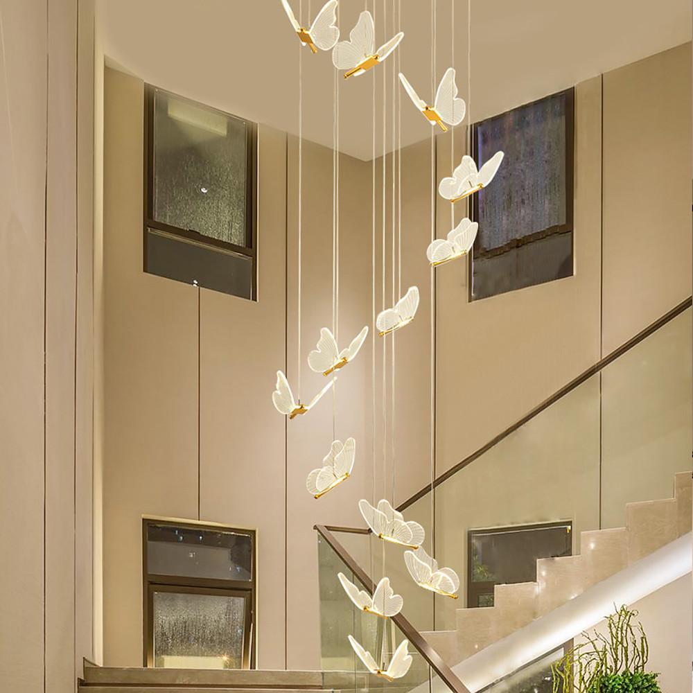 Artistic butterfly chandelier installed in a stairwell with vertical drop design.