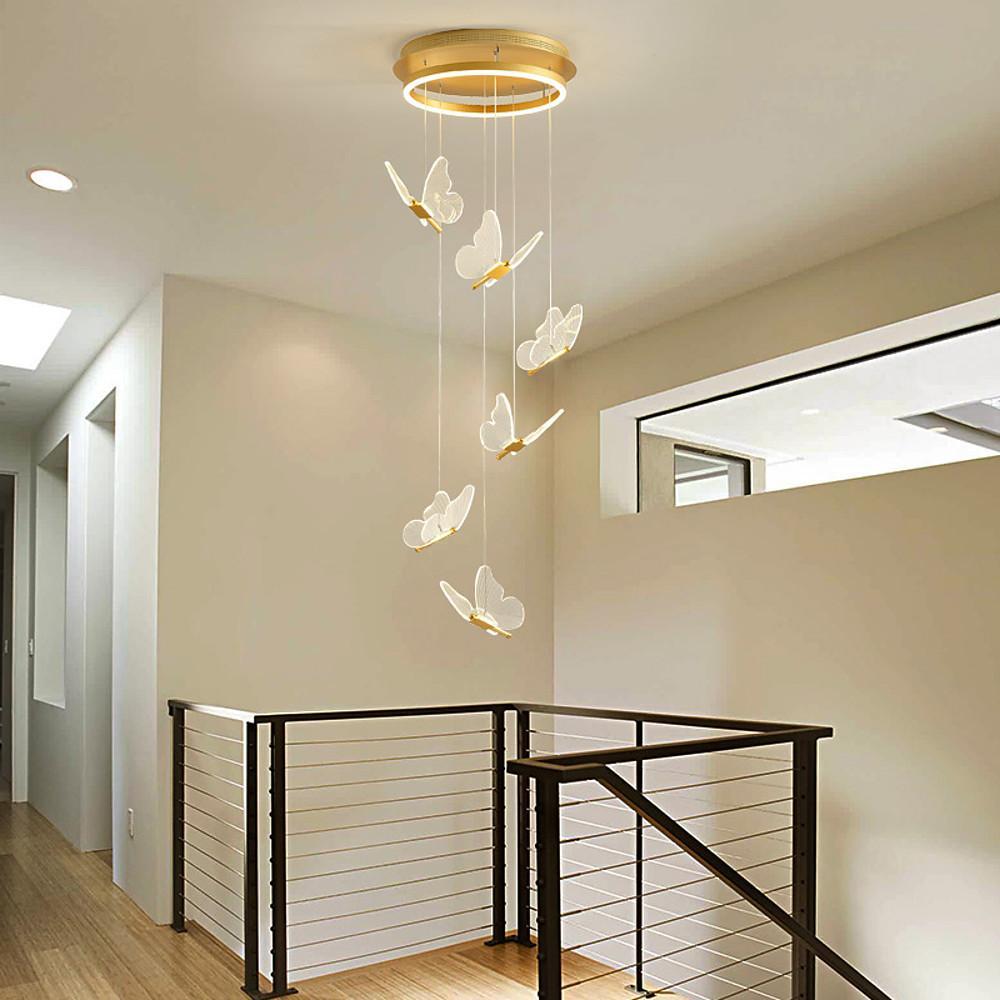 Butterfly pendant chandelier hanging over modern staircase with open space design.