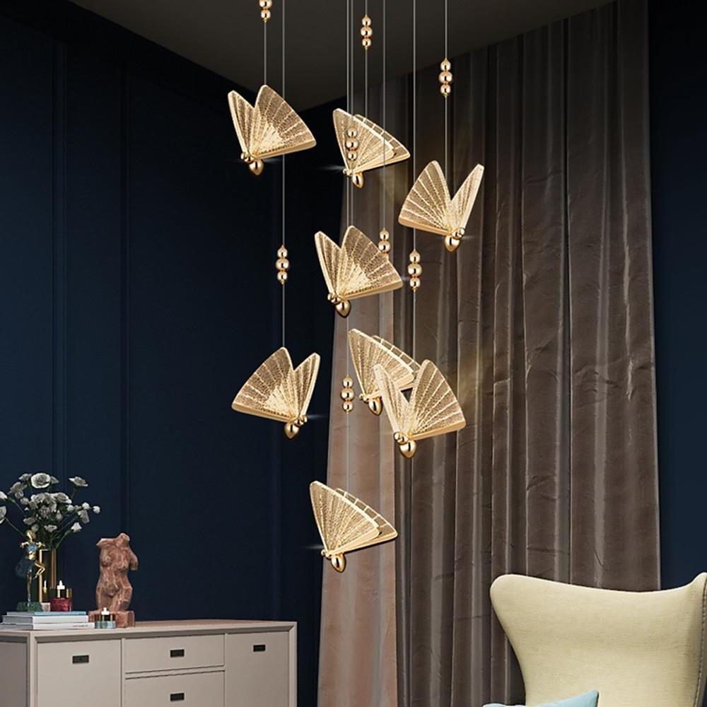 Cluster butterfly pendant light arrangement creating artistic lighting effect in living space.