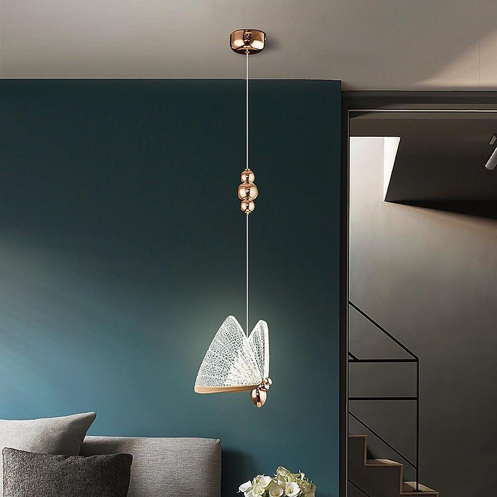 Single butterfly pendant light suspended in stairwell with decorative hanging accents.