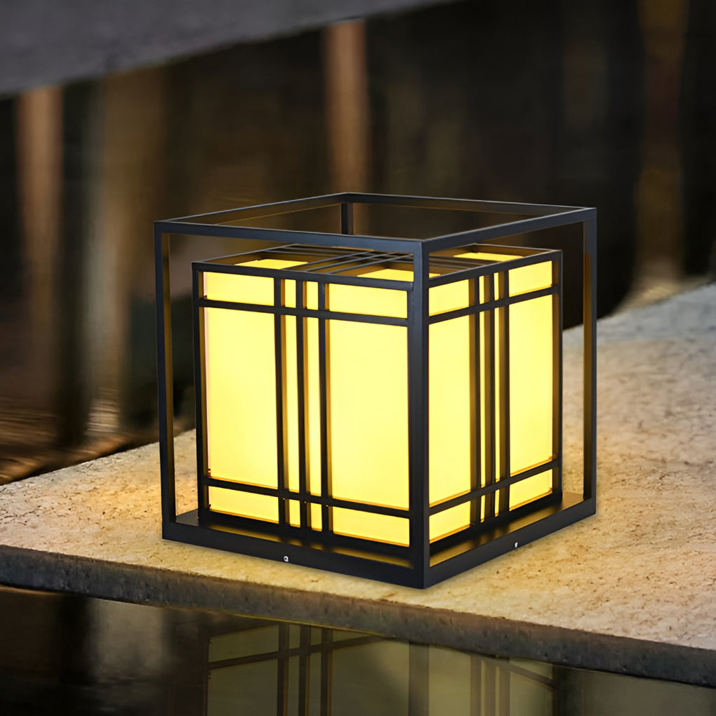 Caged pillar lights illuminating a minimalist outdoor seating area with focused glow.