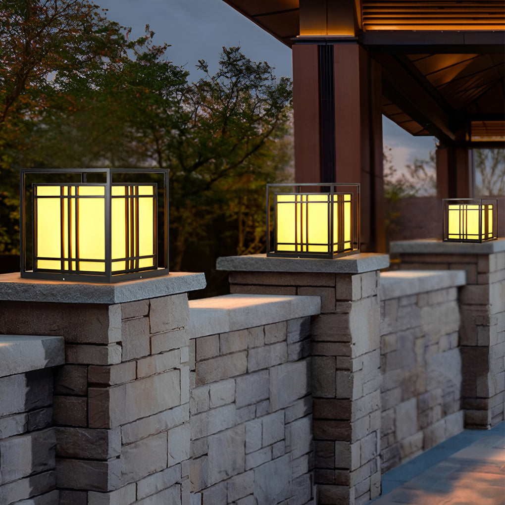Caged pillar lights enhancing a modern outdoor staircase with warm light.
