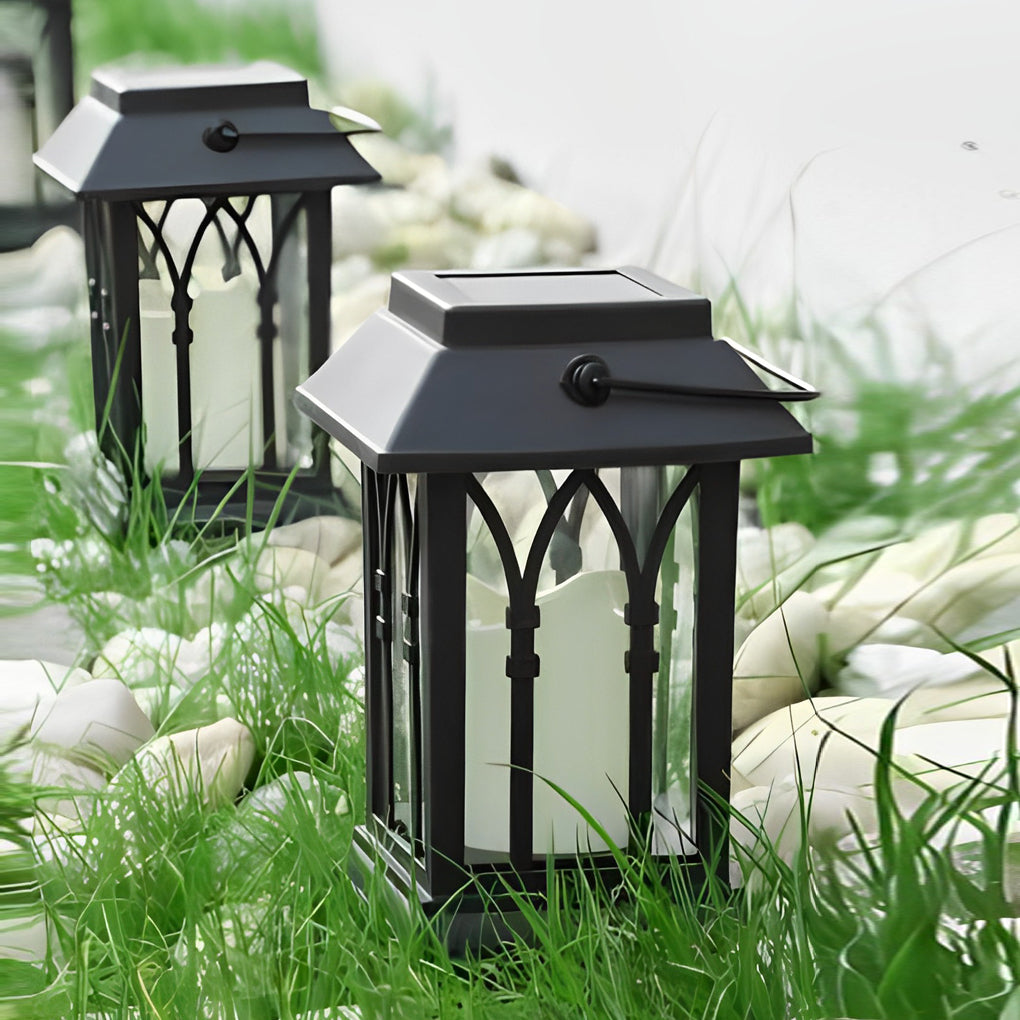 Candlestick lantern with black metal frame beside garden pond.