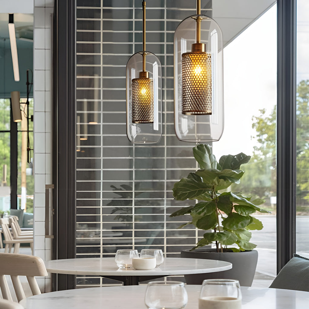 Elegant capsule Clear Glass Globe Pendant lights in a cafe setting over a marble bistro table.