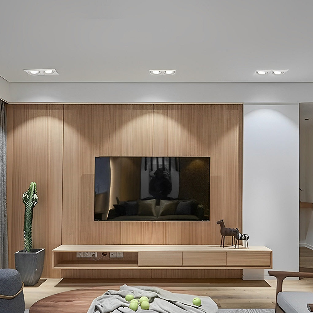 Ceiling mounted twin spotlight above TV wall in modern wood panel interior.