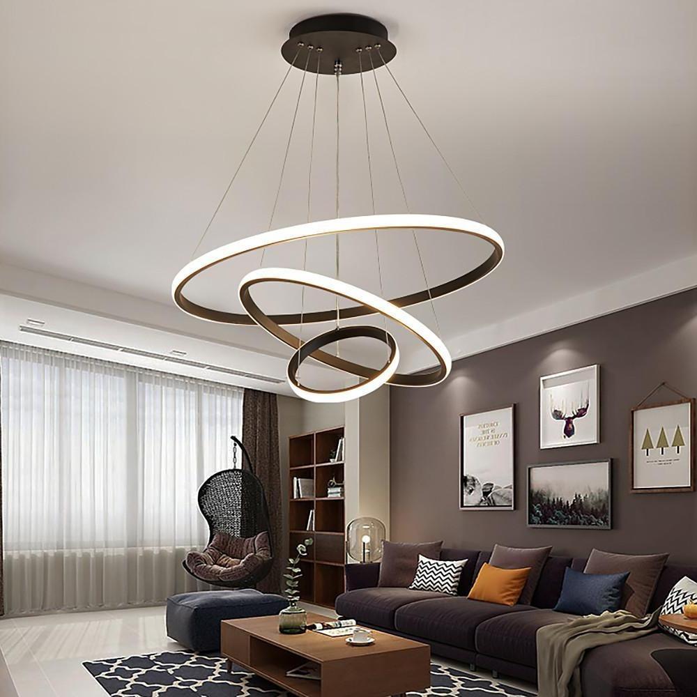Circular ring LED chandelier installed in cozy living room.