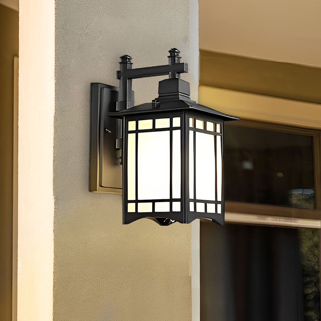 Lantern wall sconce with classic black frame and frosted glass panels mounted on exterior wall.