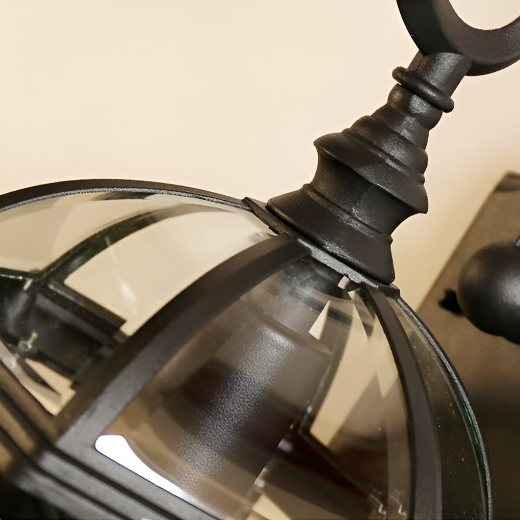 Classic outdoor wall lanterns with detailed view of their glass and metal structure.