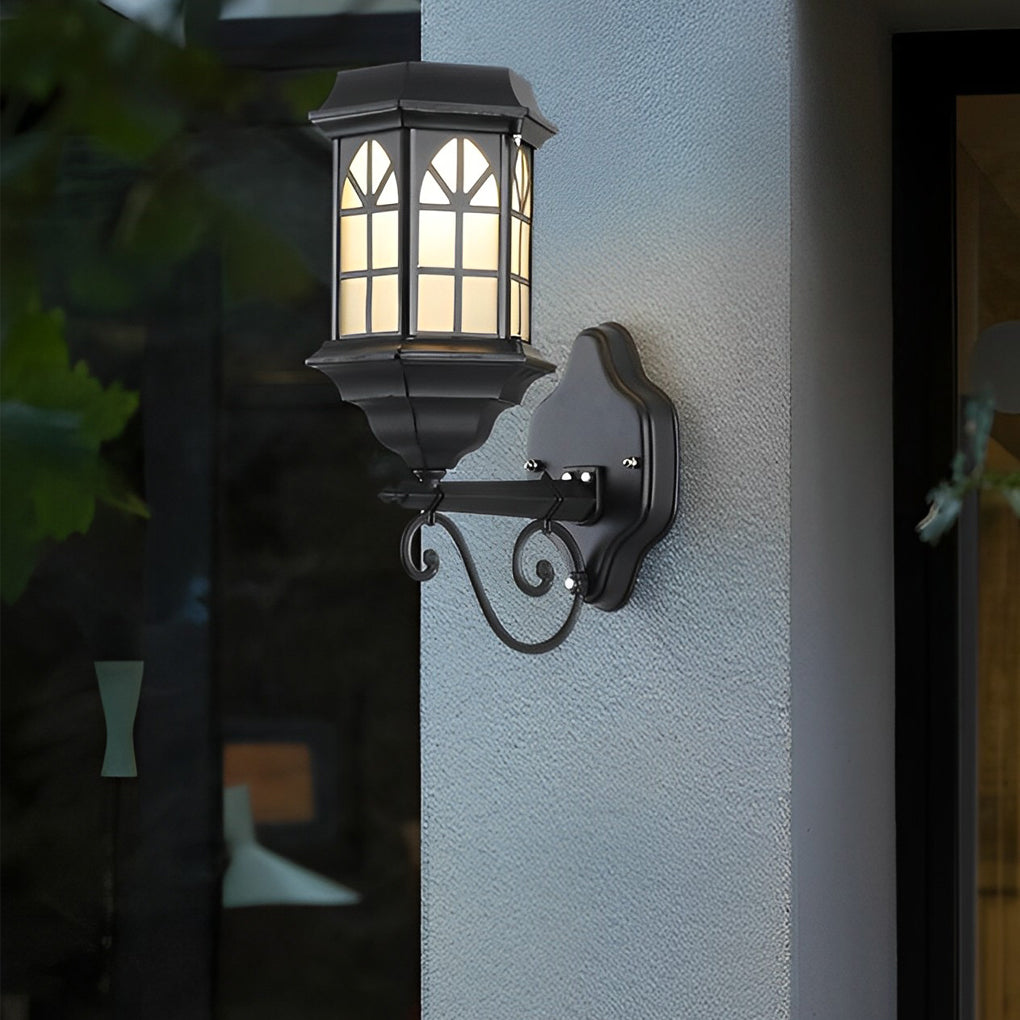 Classic porch light in black finish with decorative scrollwork and warm frosted glass for inviting entryway illumination.