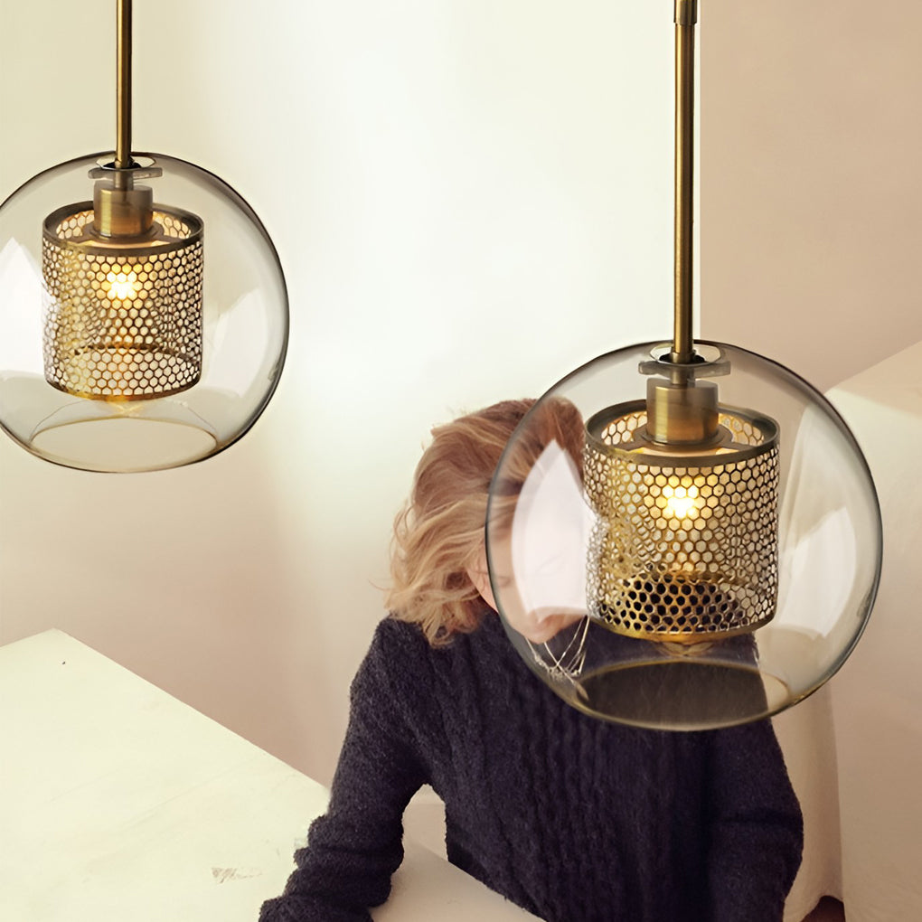 Detail of Clear Glass Globe Pendant showing the glowing brass mesh cylinder in smoke glass.