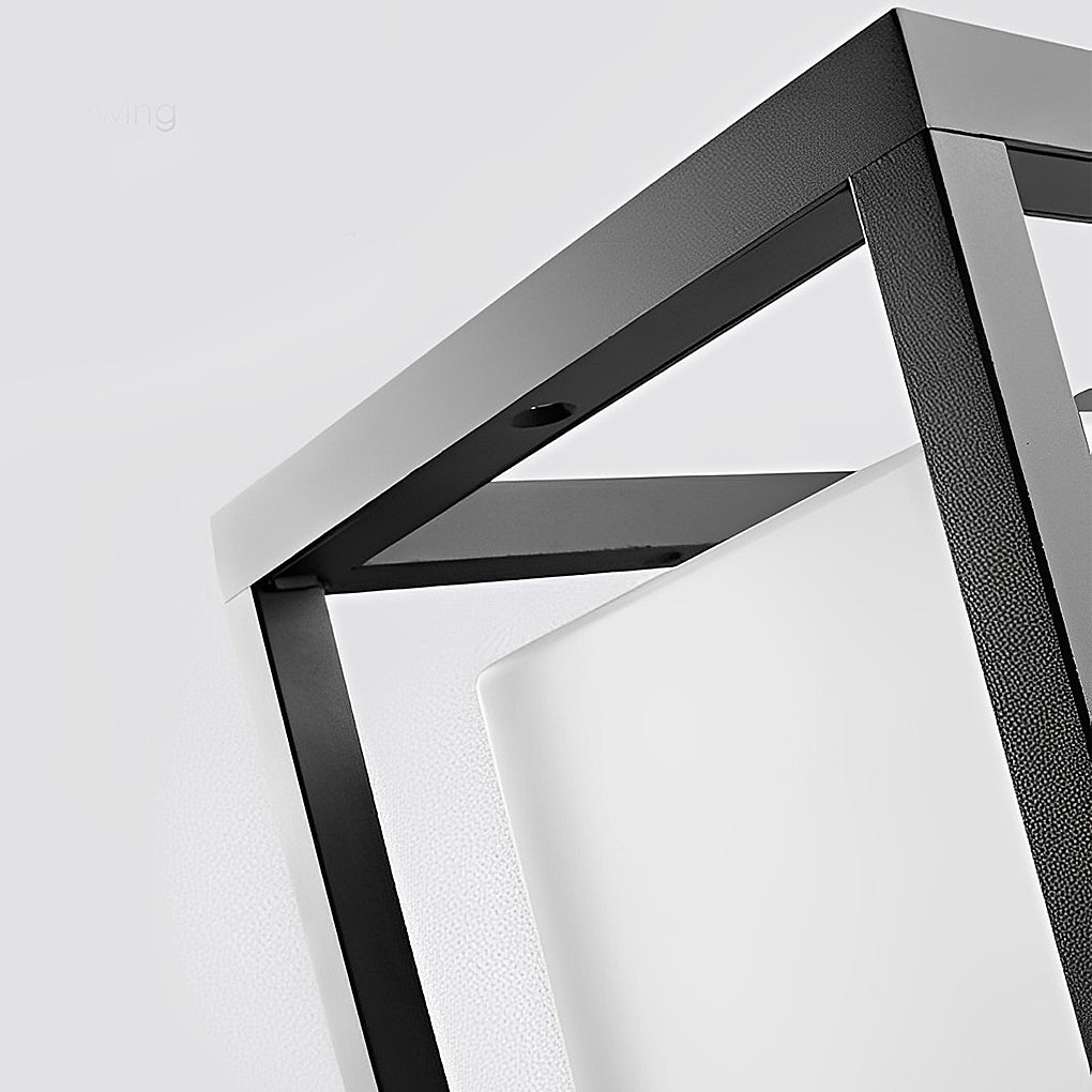 Close-up of garden pedestal lights showing sleek black frame and frosted glass.