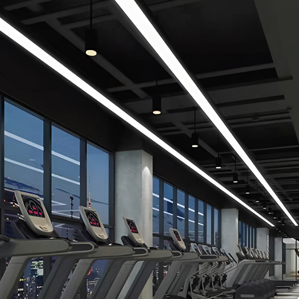 Commercial linear pendant lighting illuminating a modern fitness center