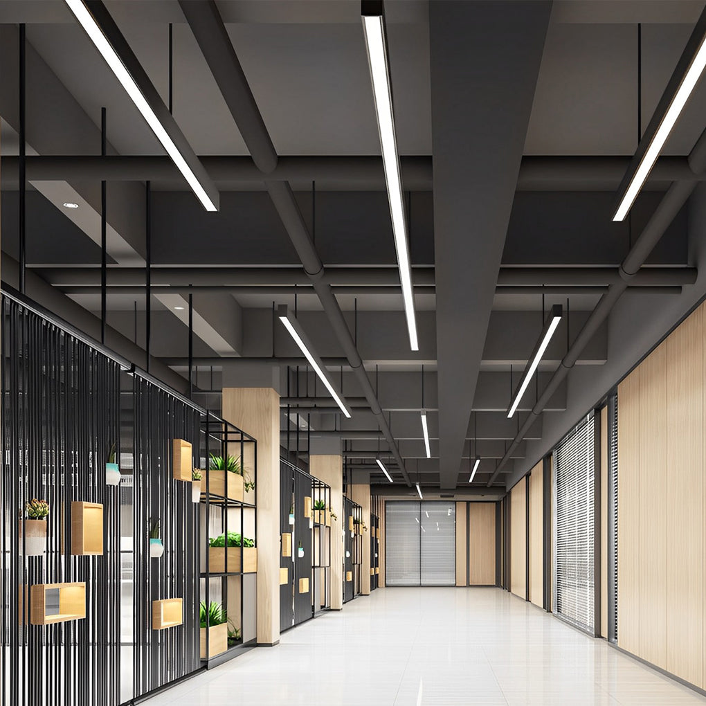 Commercial linear pendant lighting installed in a modern office corridor