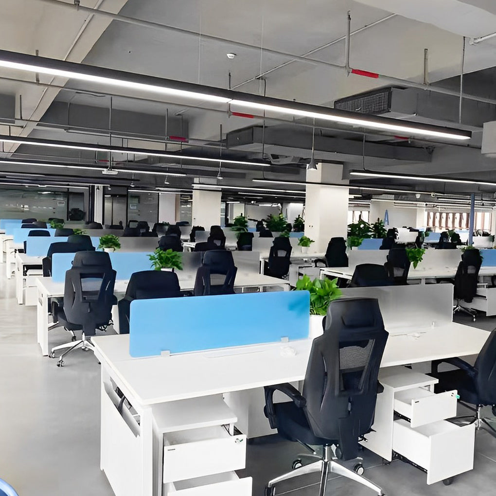 Commercial linear pendant lighting used in an open plan office workspace