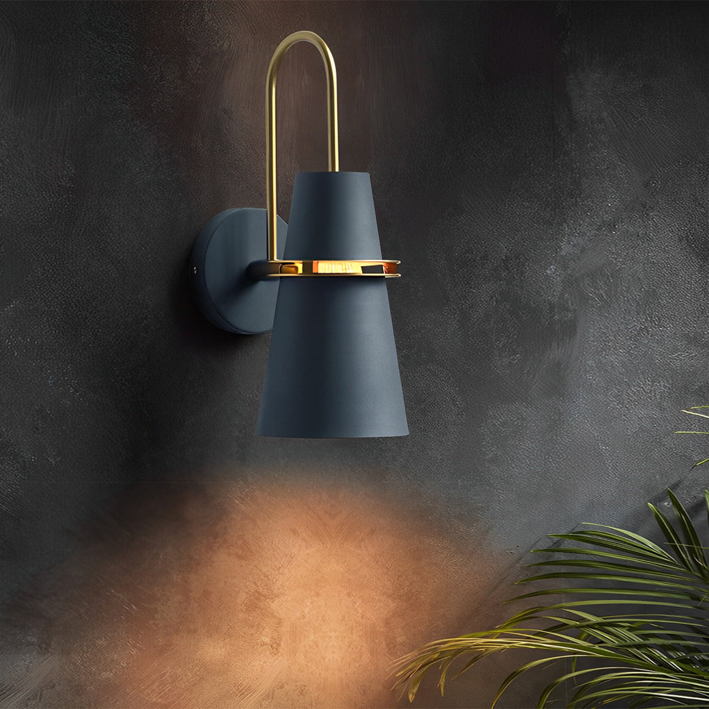 Blue cone wall lamp creating warm ambient light against dark textured wall surface.