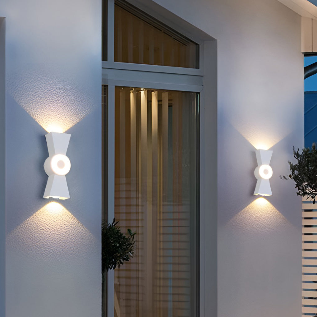 Contemporary up down wall lights casting a gentle glow on a textured exterior wall.