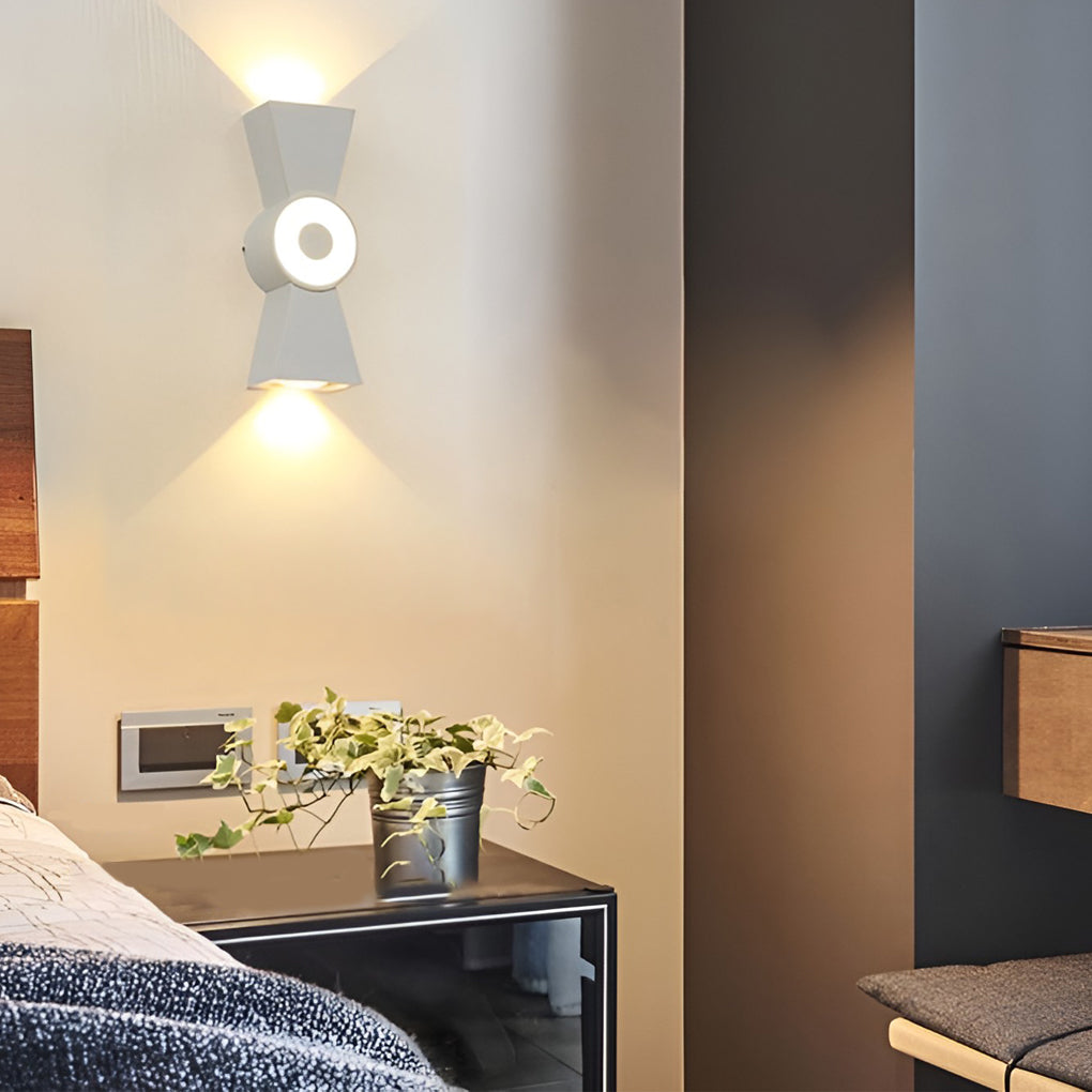 Contemporary up down wall lights illuminating a living room with modern geometric design.