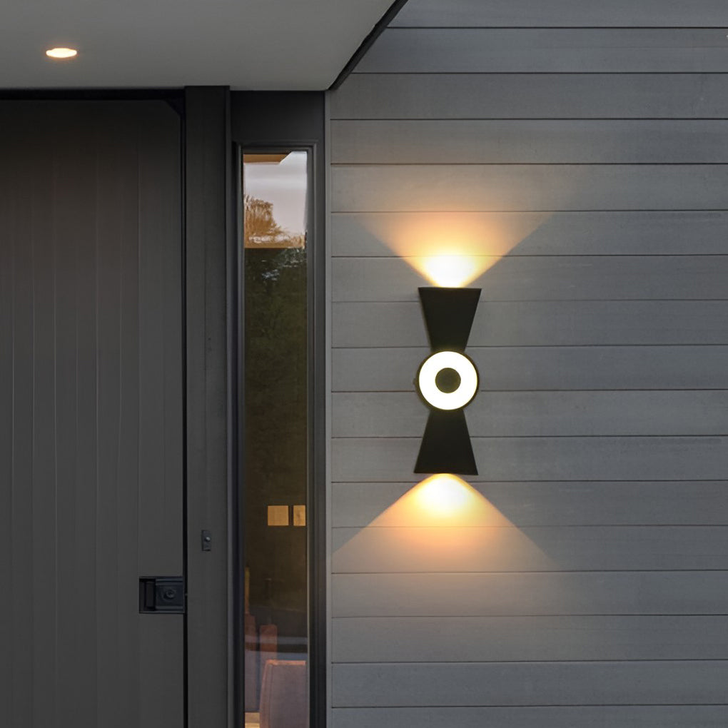 Contemporary up down wall lights illuminating a modern patio entrance with ambient light.