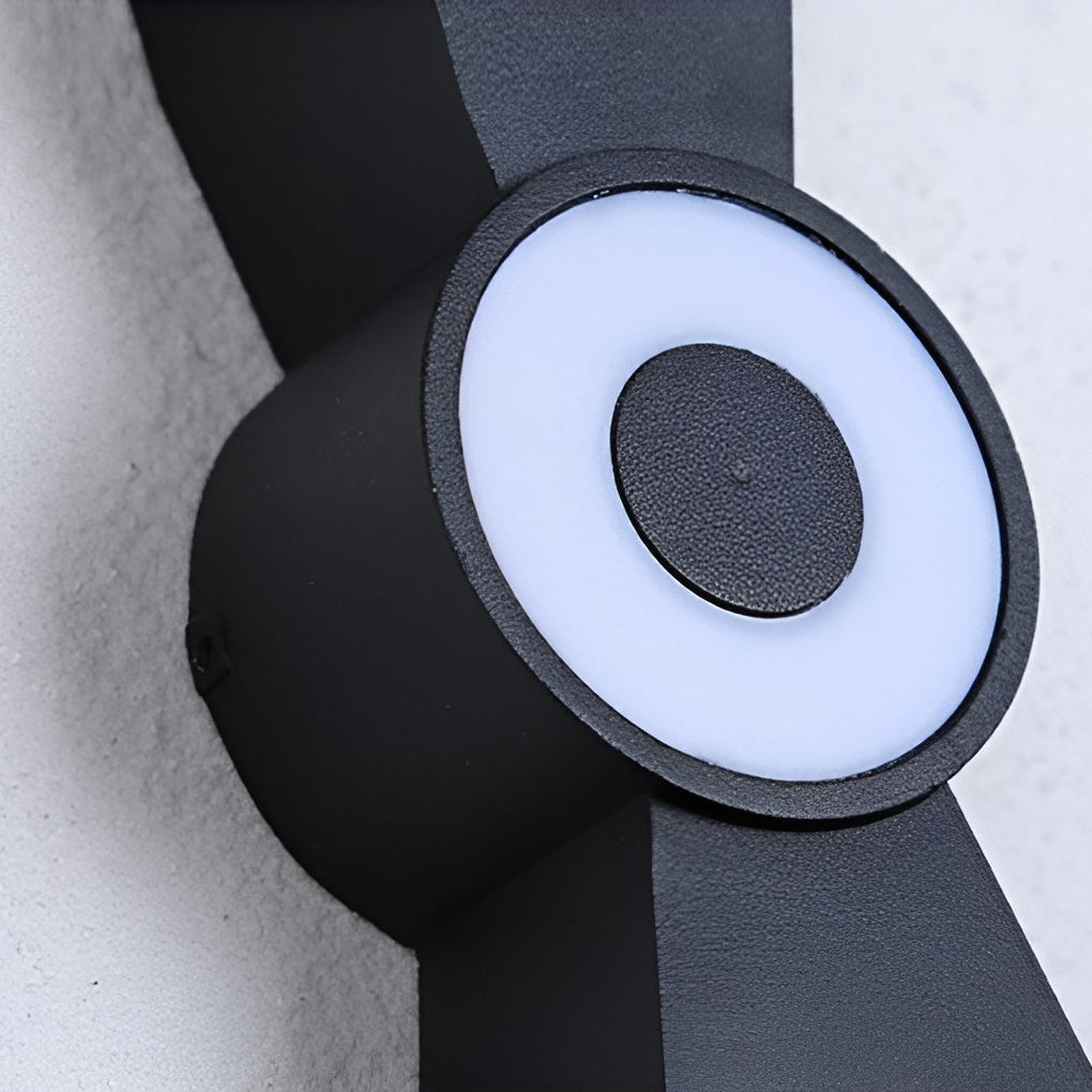 Contemporary up down wall lights displayed on a white wall, showcasing elegant design.