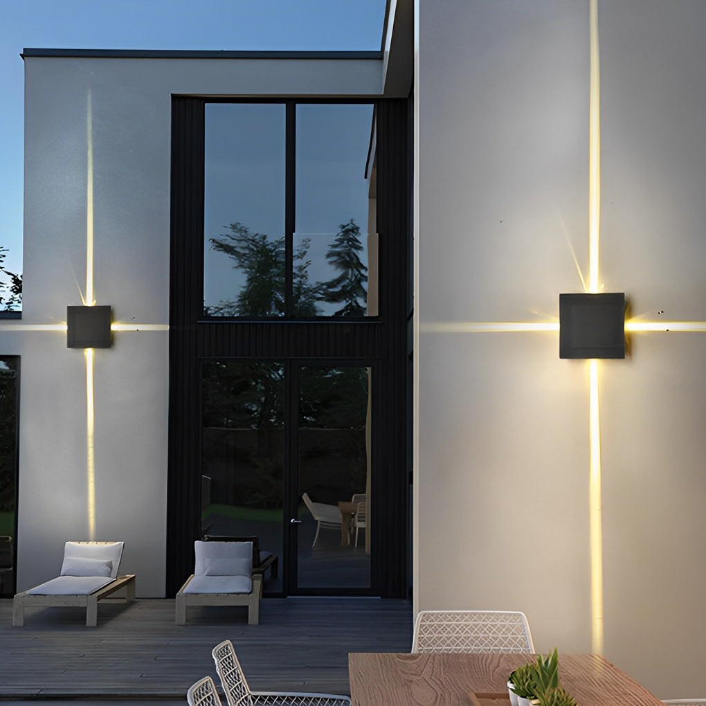 Cross light beams wall sconce enhancing a modern facade with geometric design.
