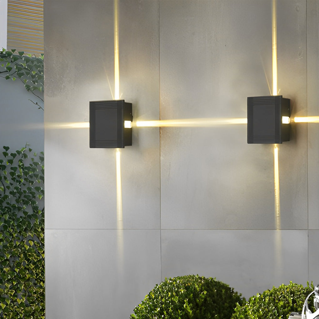 Cross light beams wall sconce providing soft up and down lighting beside a house entrance.