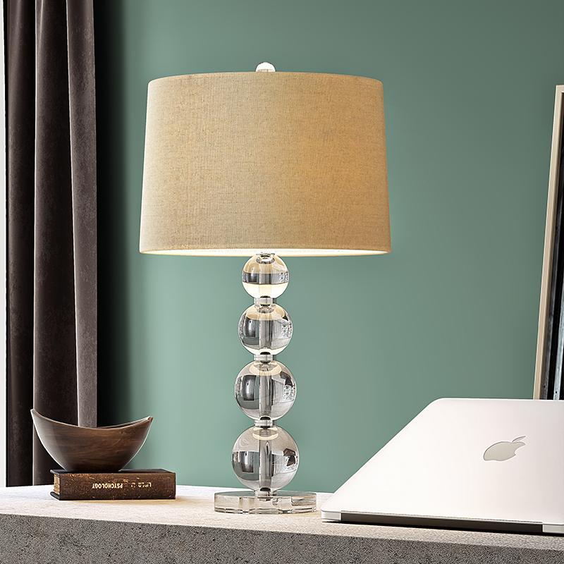 Crystal ball table lamp styled on a desk with a laptop in a home office.