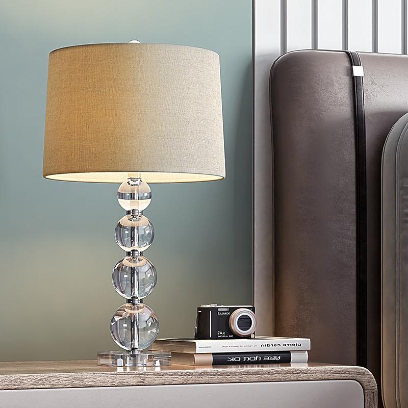 Crystal ball table lamp next to a sofa creating cozy accent lighting.